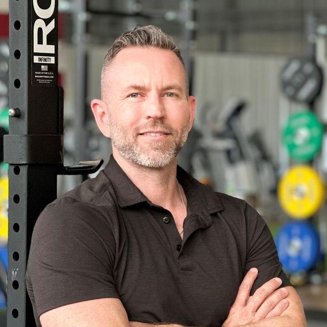 A personal trainer standing in his gym